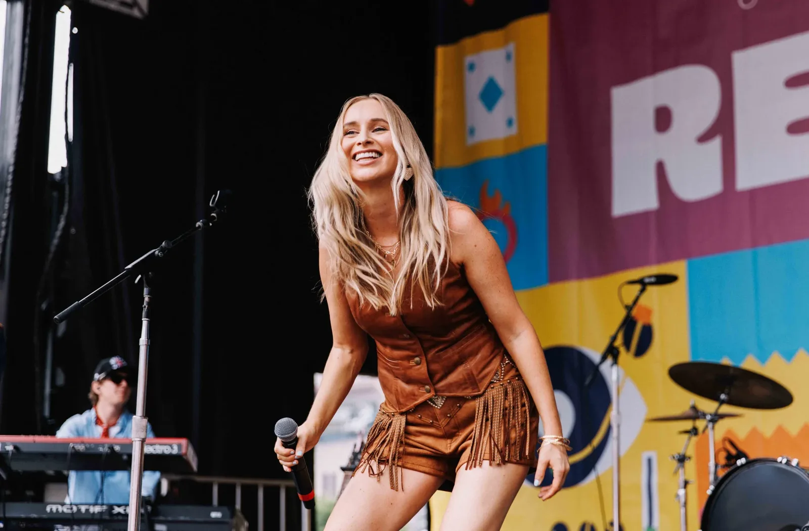 Melanie Dyer smiling on a festival stage
