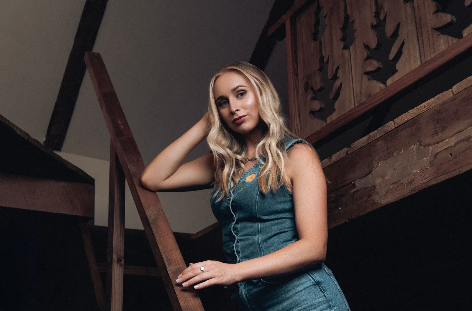 Melanie Dyer on a wooden barn staircase